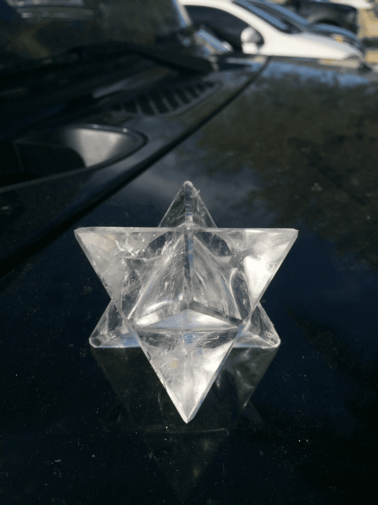 A glass star sitting on top of a table.