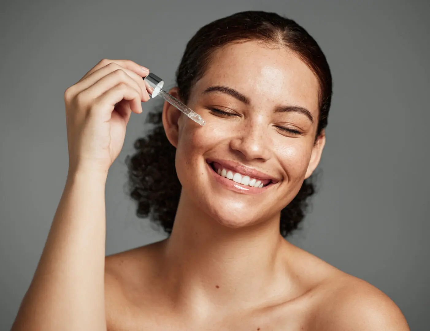 A woman holding a toothbrush in her hand.